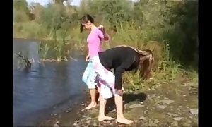 Four 18yo women in nature's set of threads apart from the river